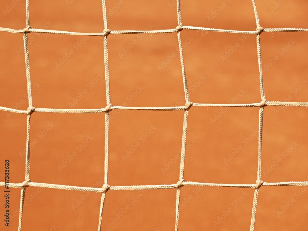 Old net with the ground and white line tennis court. Dry red clay. Light red crushed bricks surface on outdoor tenn