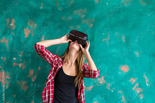 Woman in virtual reality headset enjoying her experience © satura_