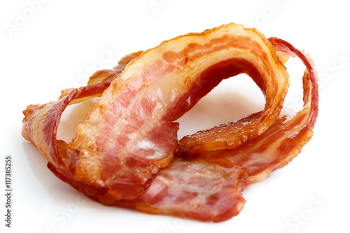 Three strips of fried crispy bacon isolated on white.