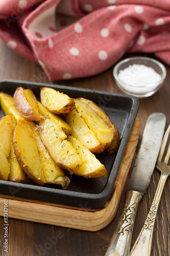 fried potato with salt, fork and knife