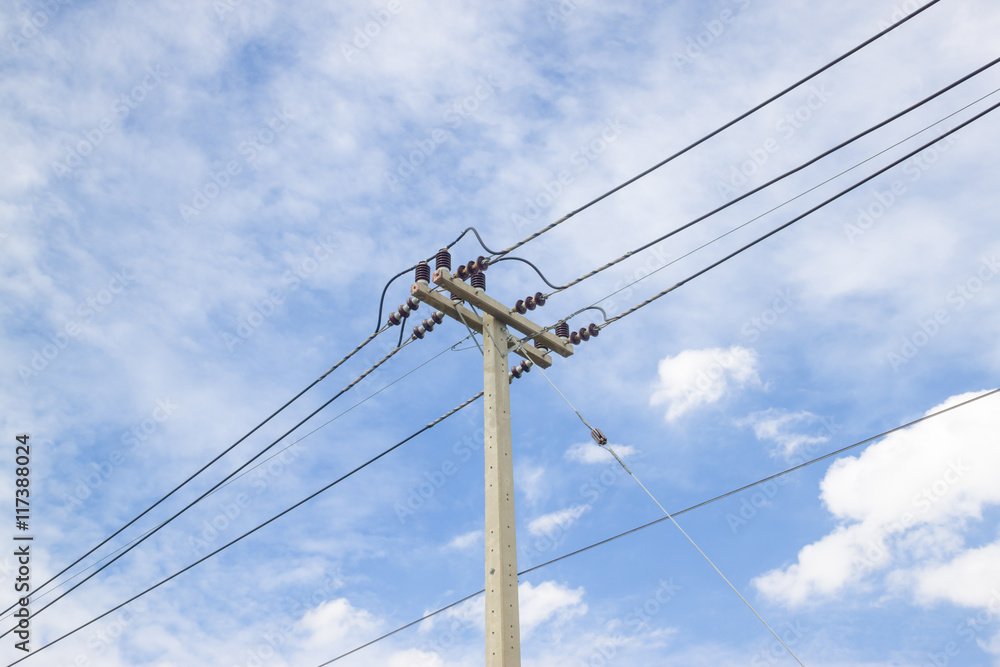 Electricity pylon silhouetted against blue sky wih cloud background. High voltage tower Electricity pylon silhouetted against blue sky wih cloud background. High voltage tower