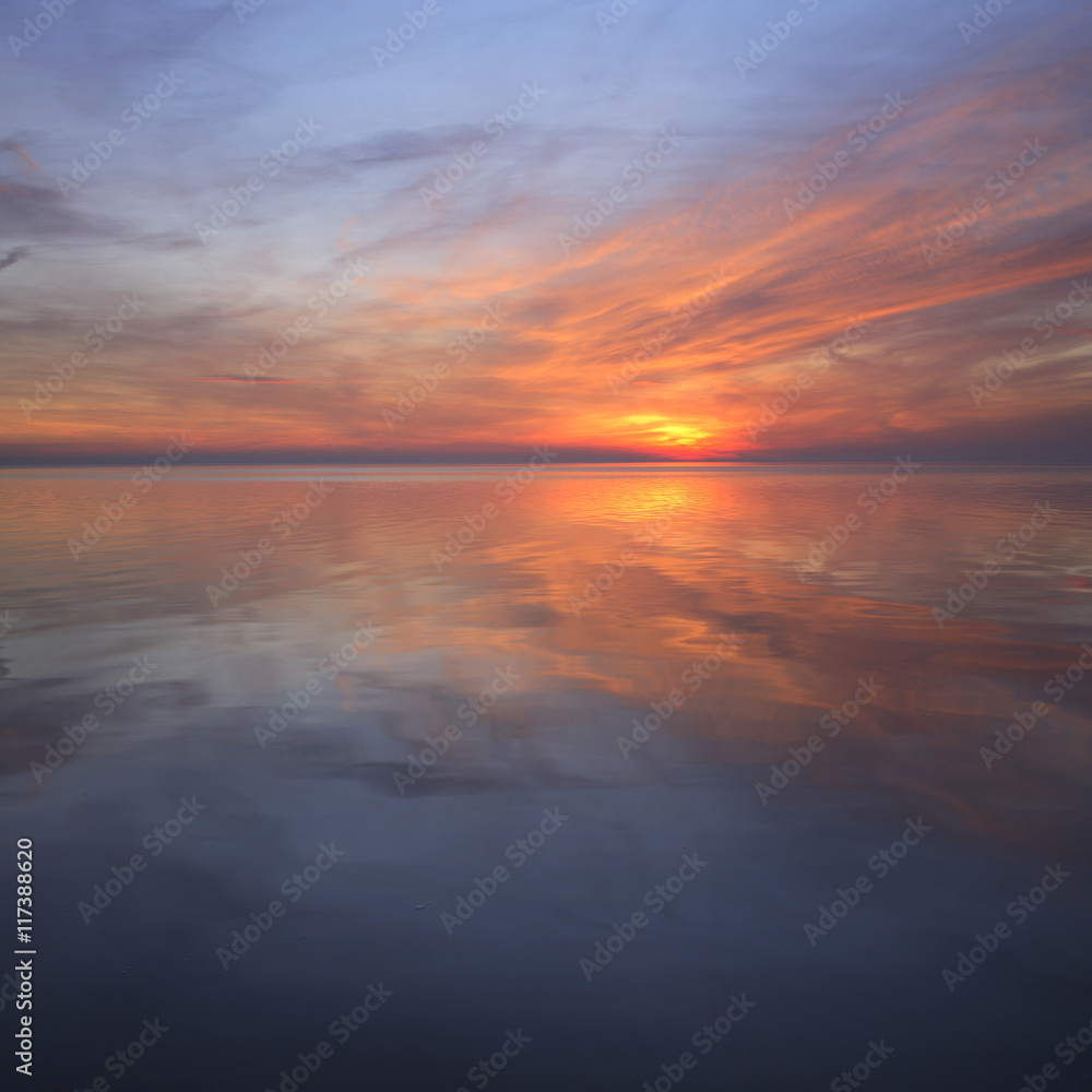 Coastal Sunset, Clouds Reflecting in the Calm Sea