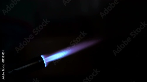 The stream of a flame escapes from a portable gas torch