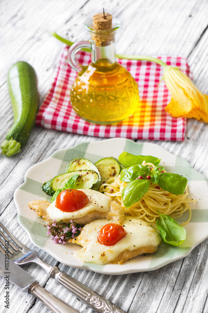 Italian lunch: chicken with mozzarella ,spaghetti and zucchini