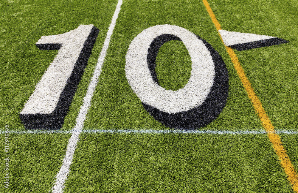 Ten yard line with white lettering on an American football field. Ten yard line with white lettering on an American football field.