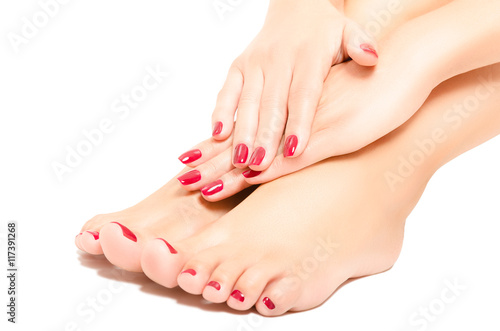 Beautiful  foot and hands with red manicure