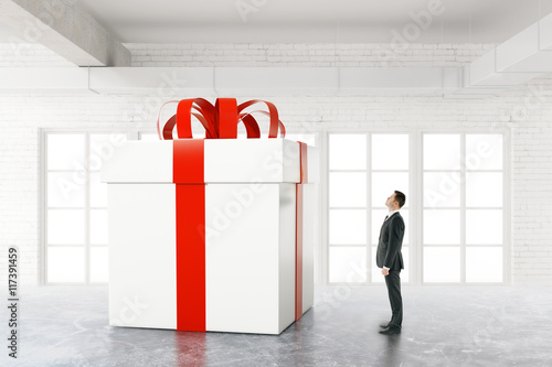 Businessman looking at huge present