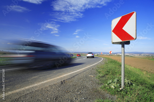 Fotografía Cars driving down a winding road, long exposure,  blurred motion