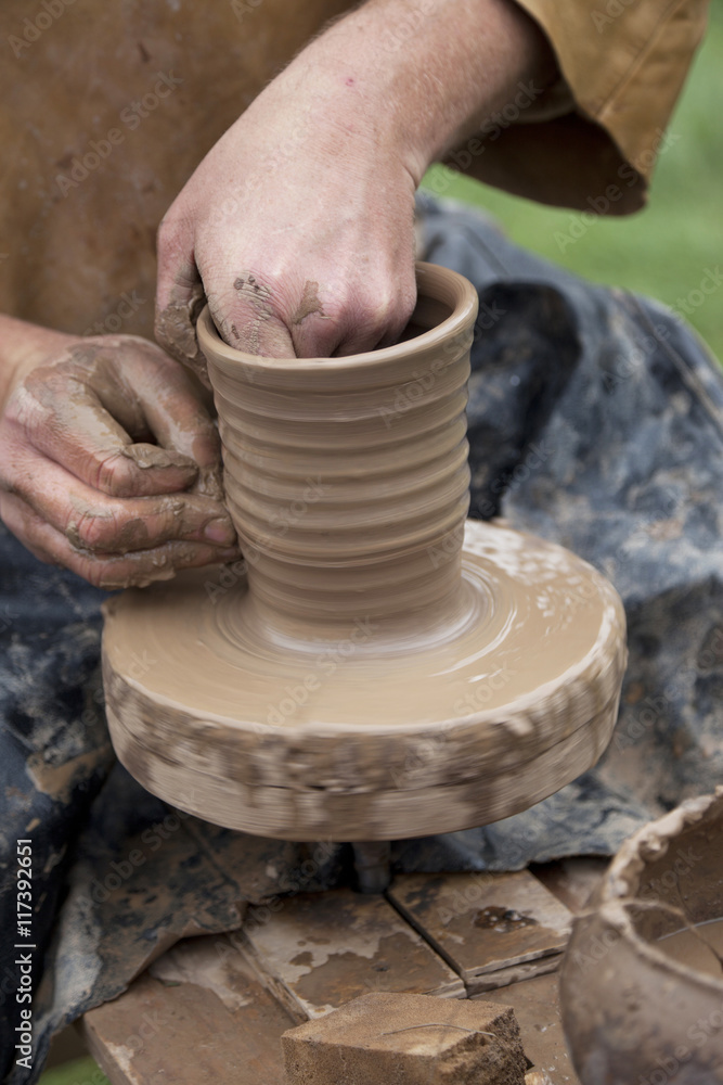 Hands working on pottery wheel Hands working on pottery wheel