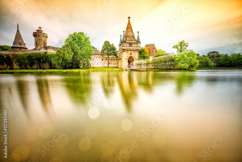 View on Franzensburg castle in Laxenburg town in Austria. Long exposure effect with glossy water and reflection. photo