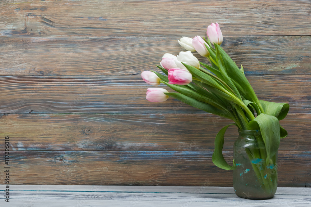 Naklejka premium Colorful tulips flowers on wooden table. Top view with copy space