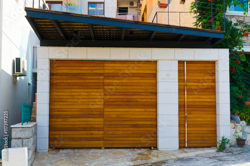 Wallpaper Mural Brown wooden gates in garage in summer sunny day with white wall. Torontodigital.ca