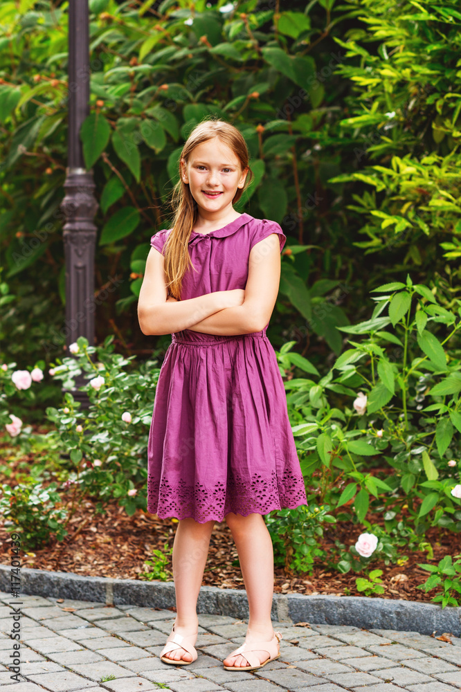 Outdoor fashion portrait of a pretty little girl, wearing maroon dress and  summer sandals Stock Photo | Adobe Stock