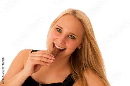 Beautiful young woman eats chocolate isolated over white backgro
