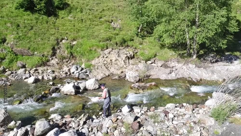 Fisherman trout fishing with bait in mountain river Fisherman trout fishing with bait in mountain river