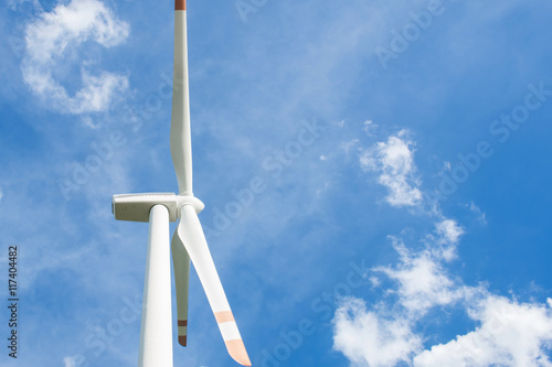Close up of wind turbine on blue sky background