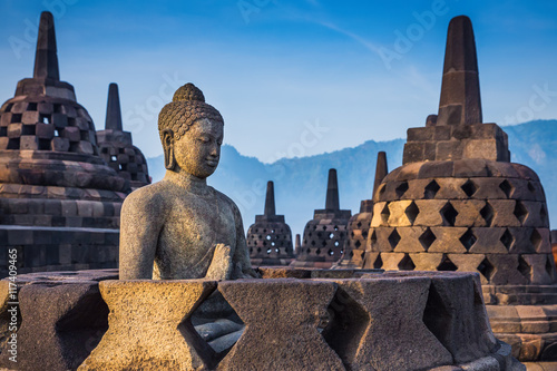 Ancient Buddha statue and stupa at Borobudur temple in Yogyakart photo