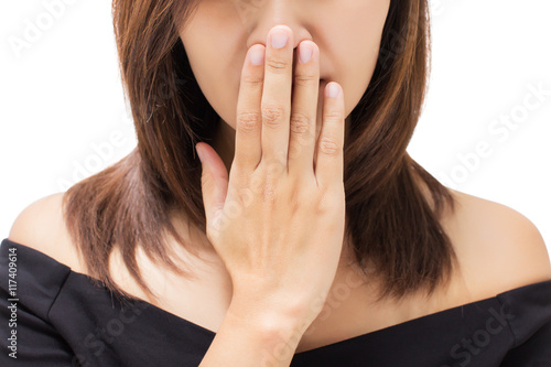Scared young woman with her hand on her mouth photo