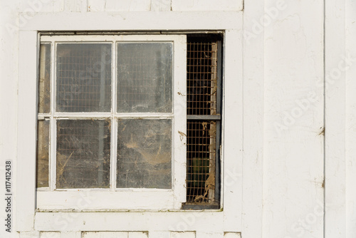 Closeup of a window in a white barn 
