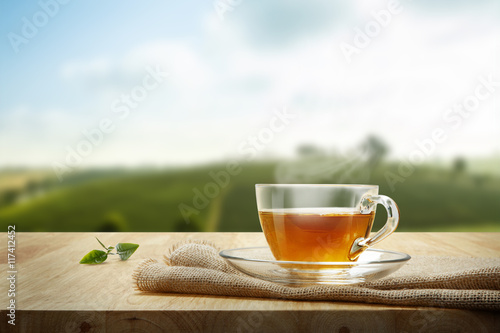 Tea cup with and tea leaf sacking on the wooden table and the te