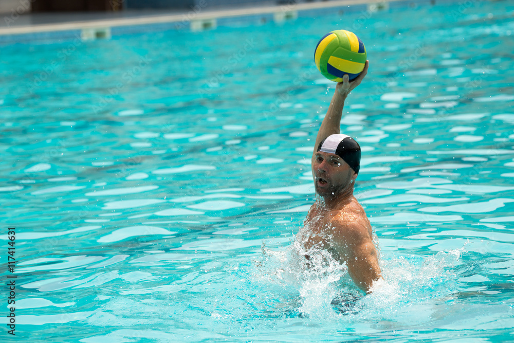 Water polo player attacks the ball with the color of the flag of Brazil - obrazy, fototapety, plakaty 