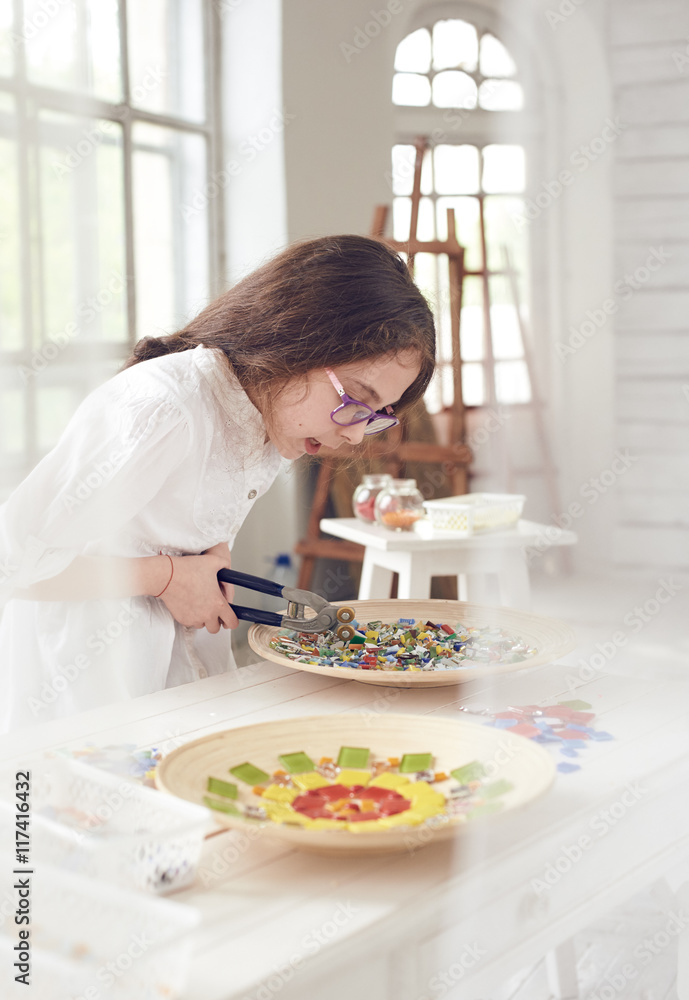 girl cutting colorful glass mosaic girl cutting colorful glass mosaic