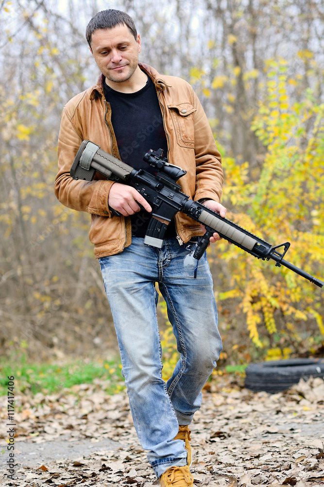 civil man walks with an automatic weapon civil man walks with an automatic weapon
