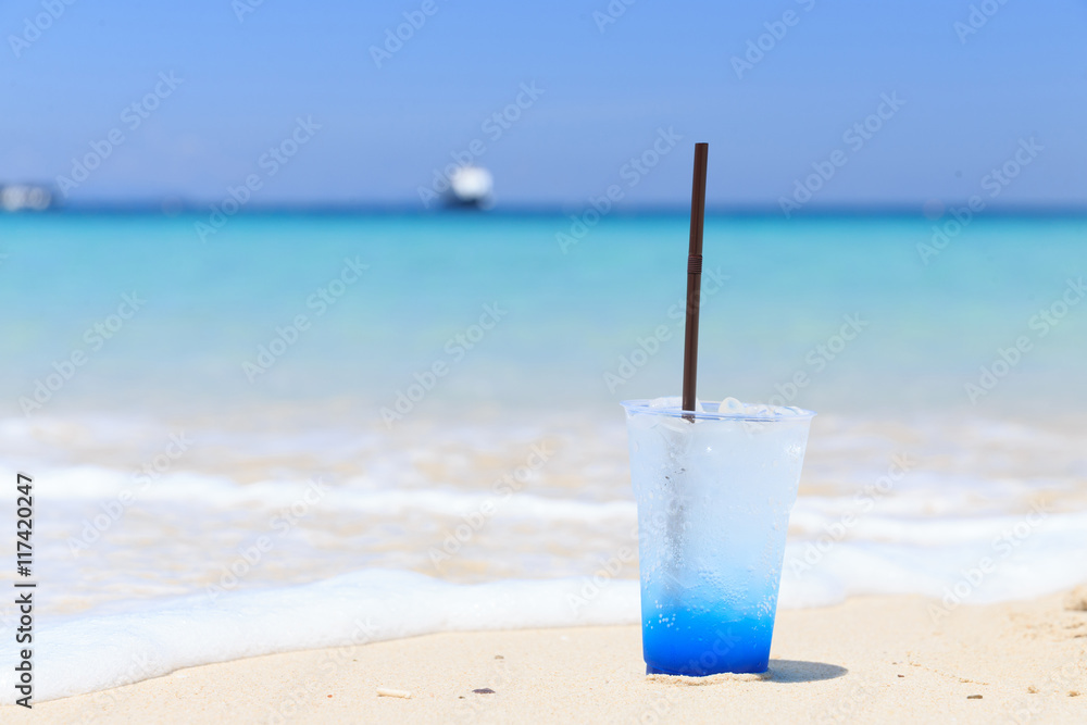 Blue hawaii soda on the colorful white sand beach,italian soda