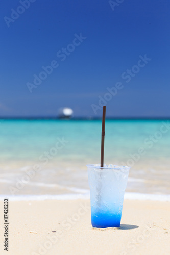 Fototapeta Naklejka Na Ścianę i Meble -  Blue hawaii soda on the colorful white sand beach,italian soda