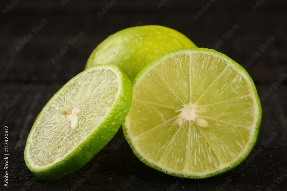 Slices of organic lime in dark background, Slices of organic lime in dark background,