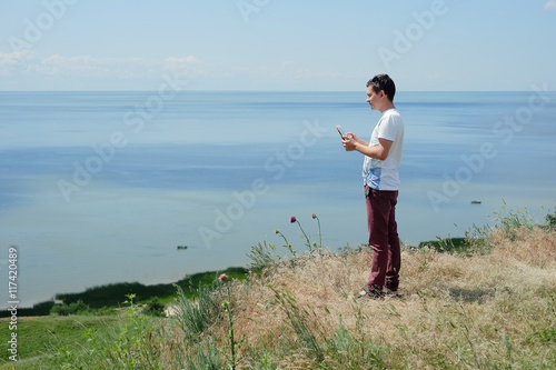 the guy on the beach with a tablet © lanarusfoto