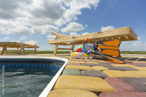 Chaise lounge by the pool . photo