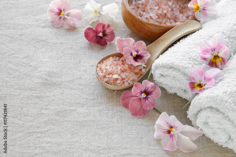 Pink sea salt and flowers, Spa setting, copy space background Pink sea salt and flowers, Spa setting, copy space background