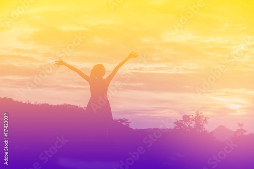Young woman enjoying beautiful sunset.