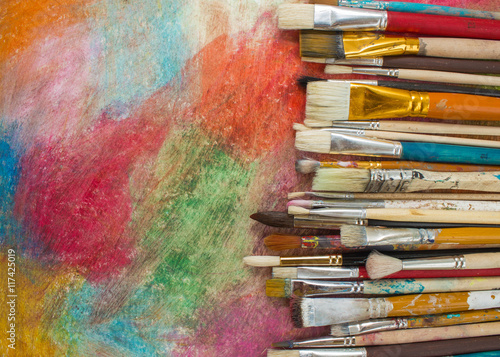 Brushes on a colorful background. The workplace of the artist. Banner for school