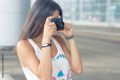 Beautiful young woman makes the film photo. Tourism