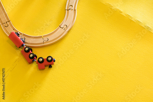 red wooden toy train crashed off track.