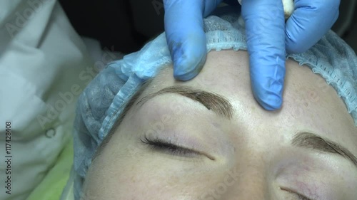 Microblading procedure. Master works with the eyebrows. Semi-permanent make-up.