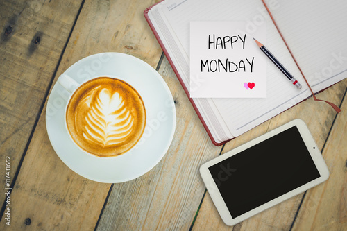 Happy Monday on paper with coffee cup on wood background