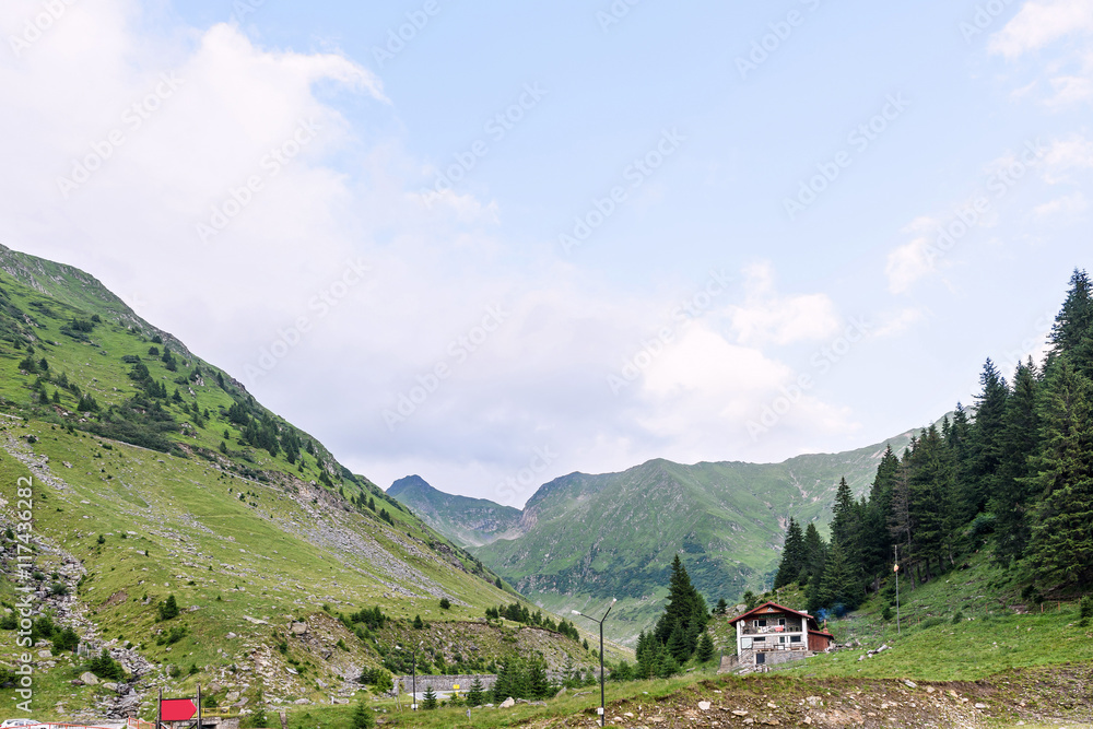 Photo of green capra peak, and a road in fagaras mountains, Romania.