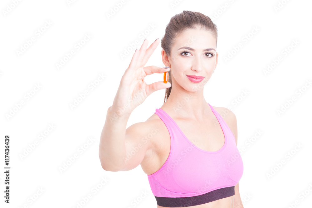 Young girl at gym showing one pills Young girl at gym showing one pills