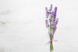 Bundle of lavender on old wooden board painted white.