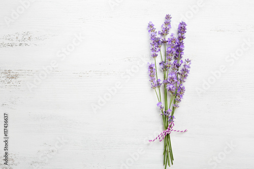 Fototapeta Naklejka Na Ścianę i Meble -  Bundle of lavender on old wooden board painted white.