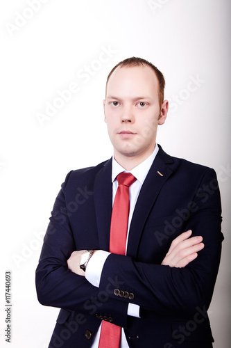 Successful businessman in formal suit chacking time on wrist watch isolated over white.