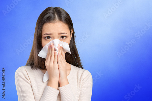 Young woman with handkerchief having cold