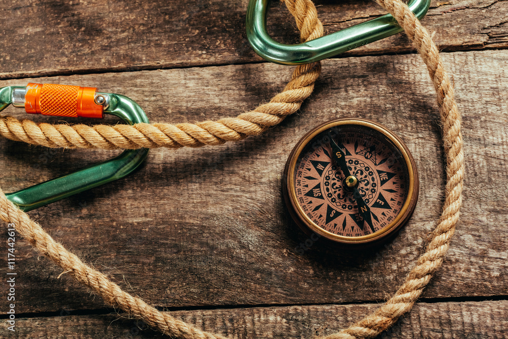 ship ropes and compass on wooden background