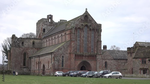 Lanercost Priory Abbey ancient historic building England couple. Founded in 1169. Dedication is to St. Mary Magdalene. Priory buildings were constructed from stones derived from Hadrian's Wall. photo