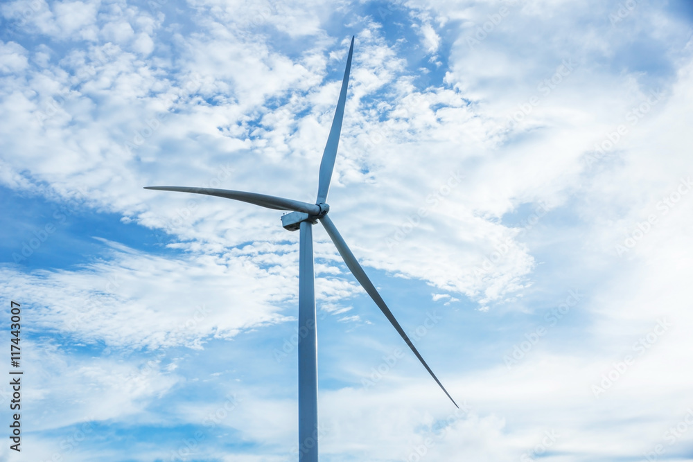 Wind turbine on the blue sky.