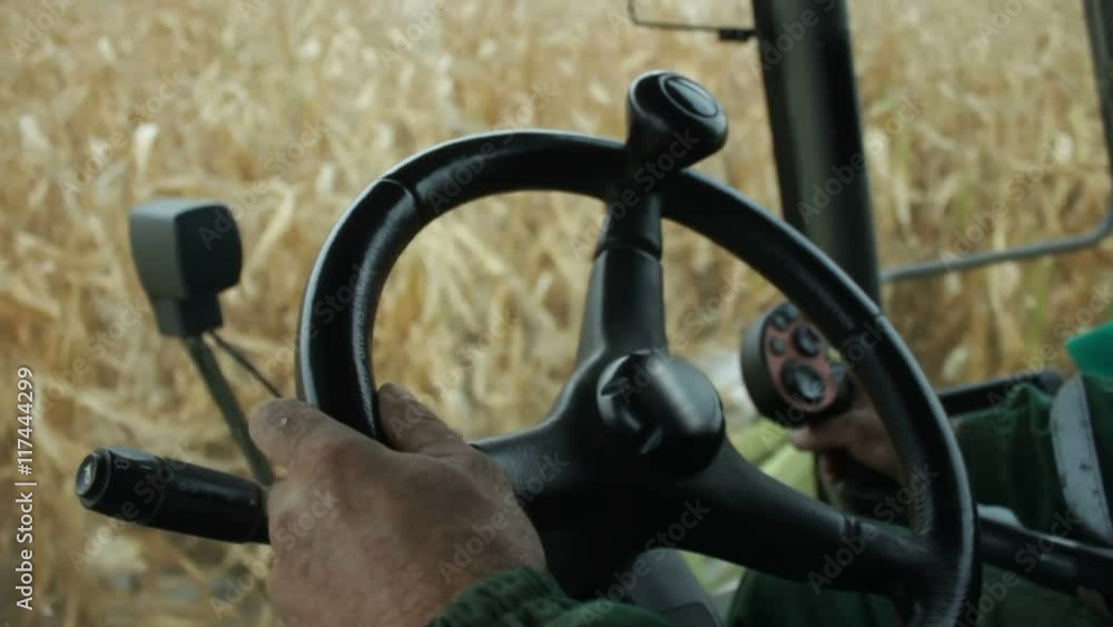 In the cab of combine harvester gathering corn In the cab of combine harvester gathering corn