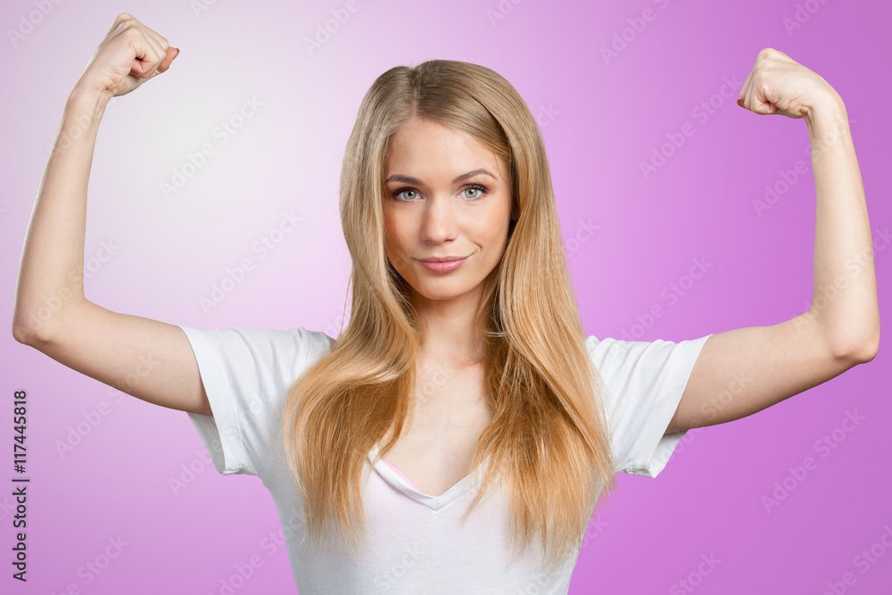 Pretty young blonde woman throwing her arms up into the air in jubilation of her success Pretty young blonde woman throwing her arms up into the air in jubilation of her success